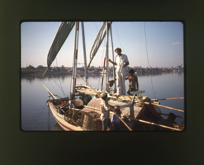 Adrian Horridge in Makassar Harbour, South Sulawesi, inspecting a patorani fishing sailboat in 1979/ Audrey Horridge photograph, film 107 of the Adrian Horridge Archive